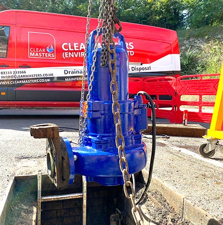 A submersible pump being lifted out of a pump station