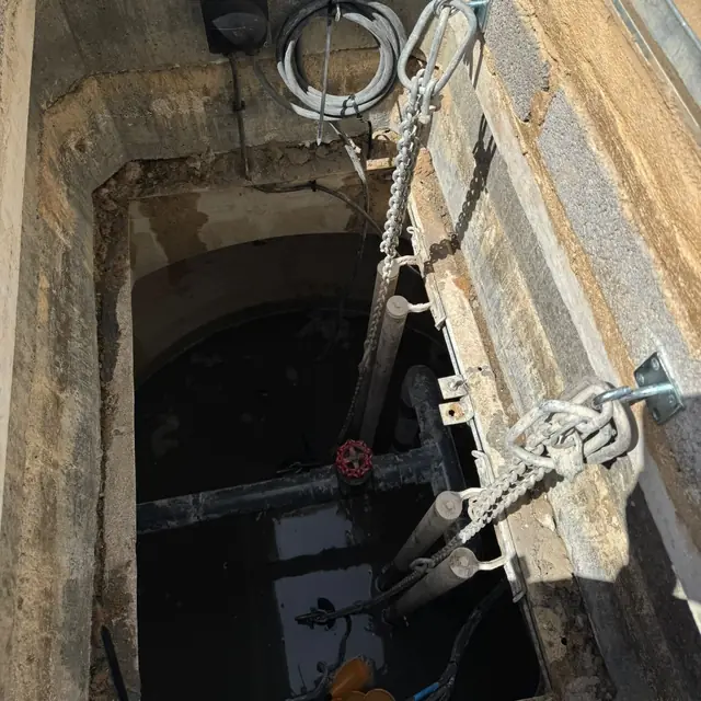 Two new pumps on guide rails in the wet well of the Copthorne pump station